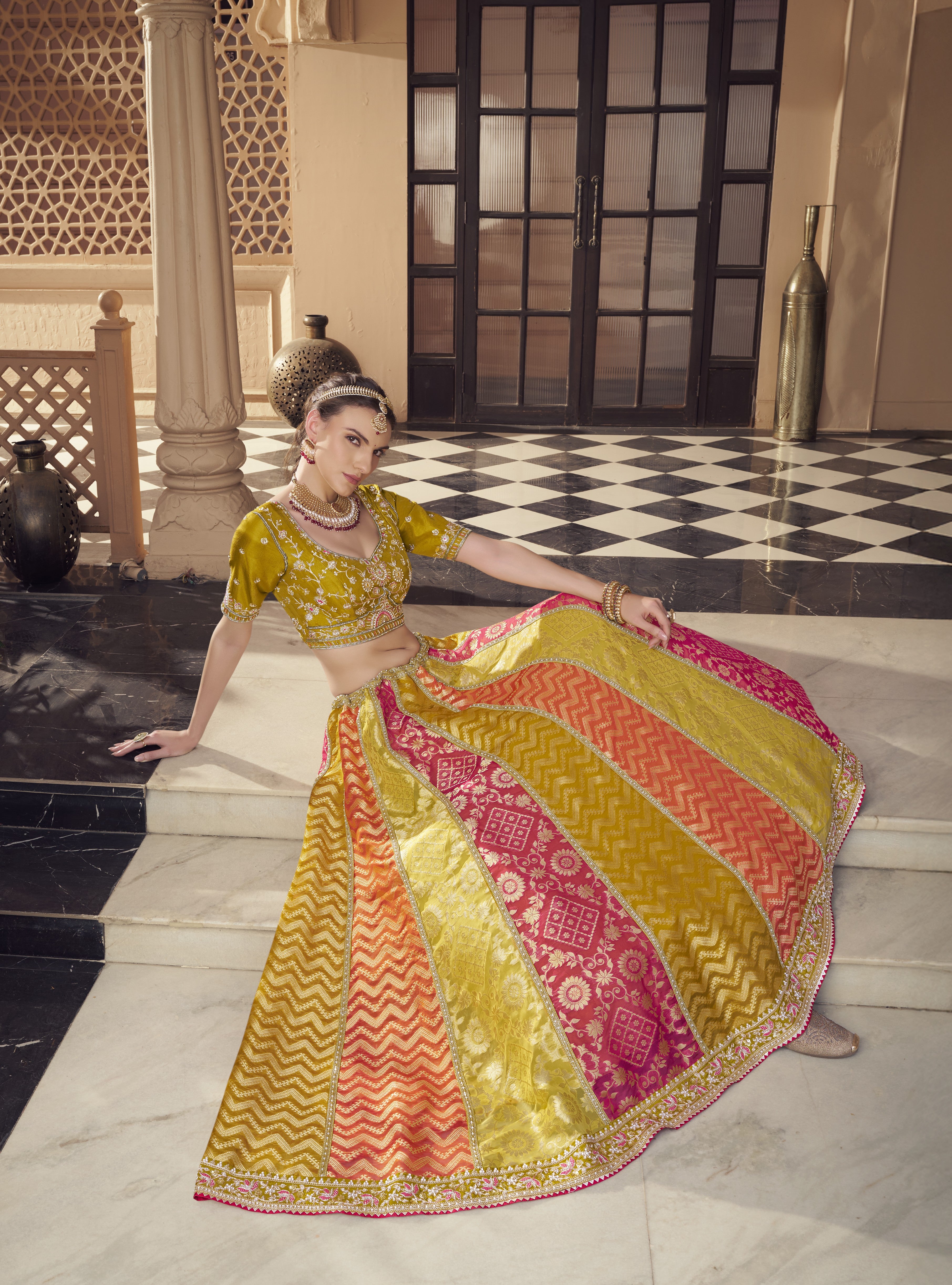 Woman in a colorful traditional Lehenga standing on a checkered floor.
