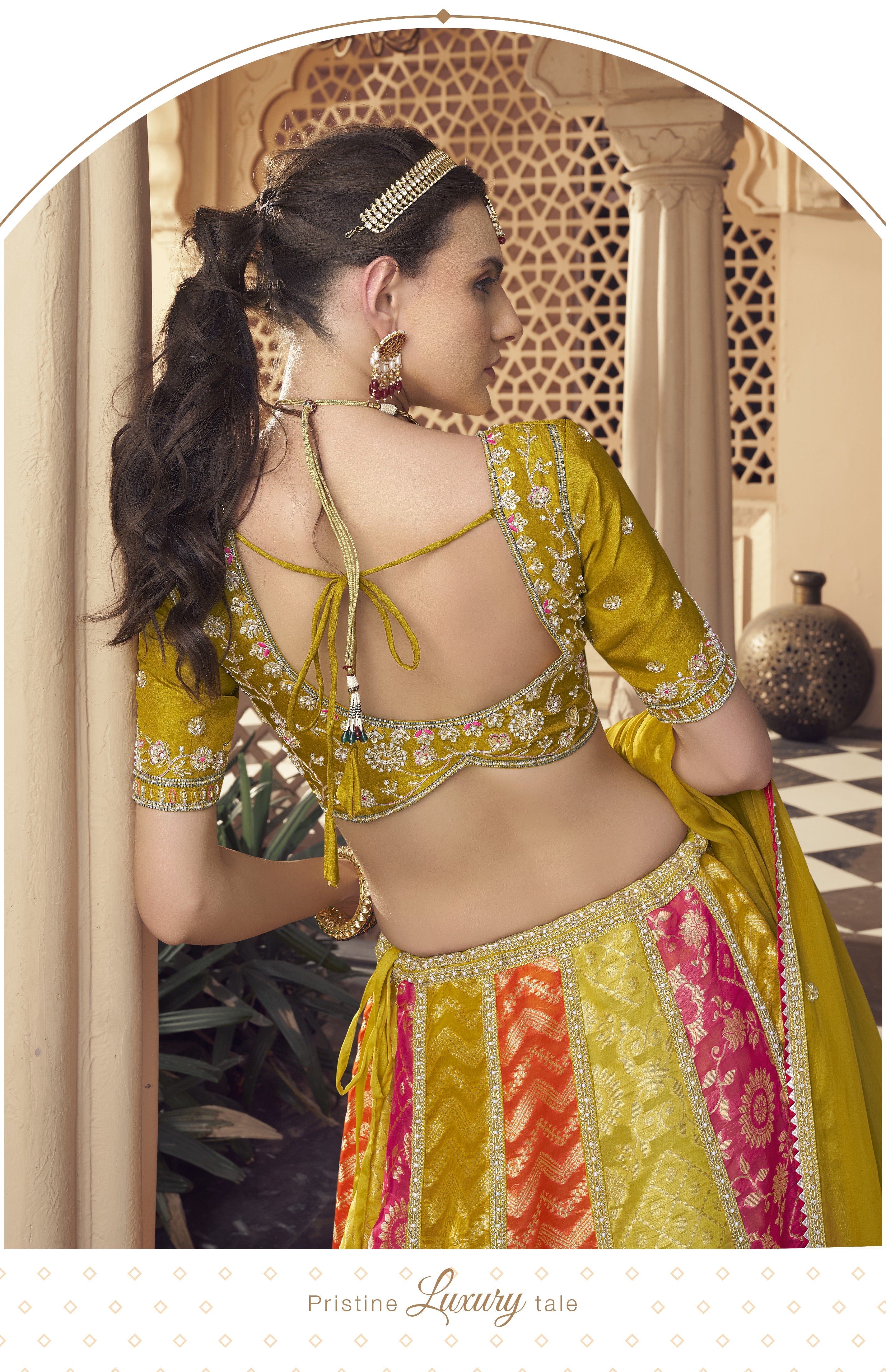 Woman in a colorful traditional Lehenga standing on a checkered floor.