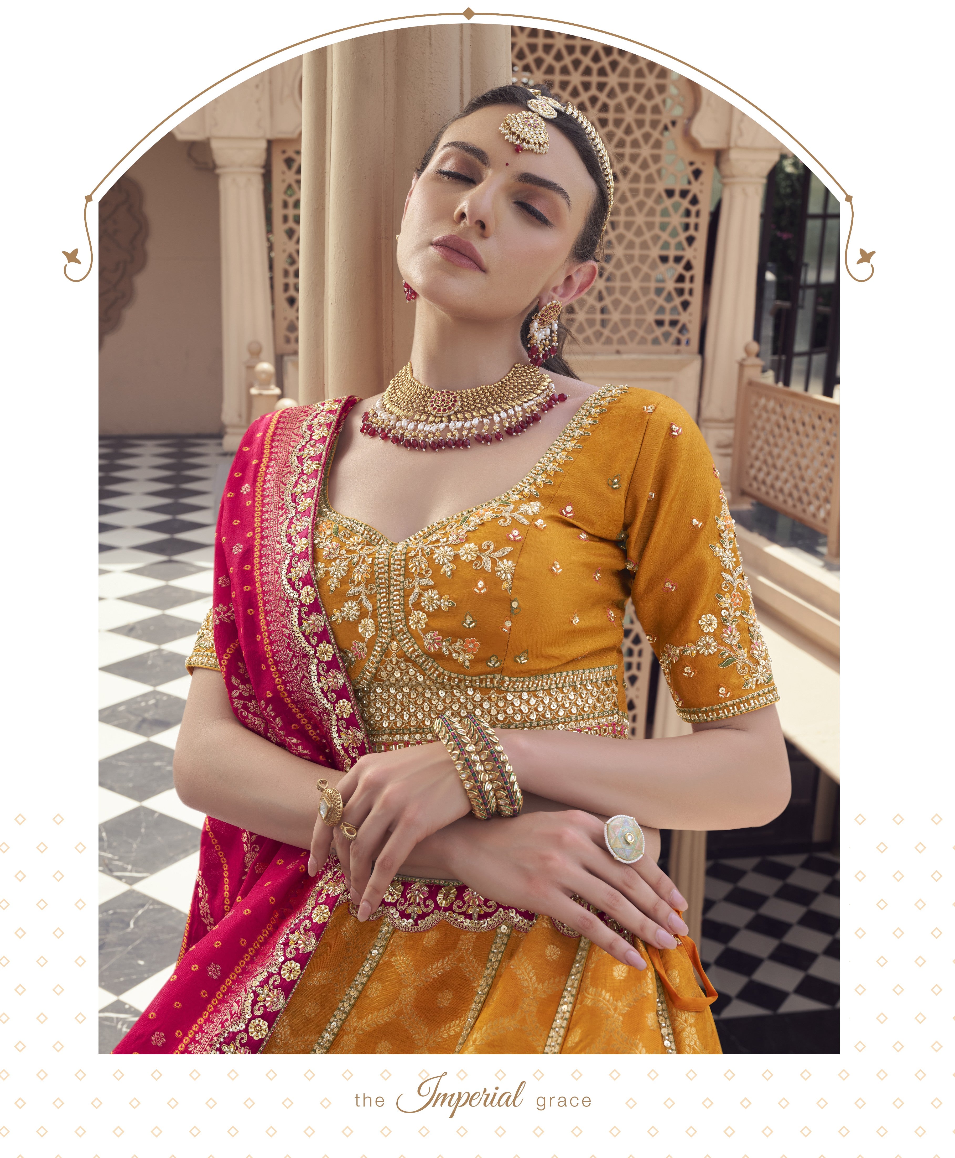 Woman in traditional yellow and pink embroidered Lehenga with jewelry outdoors.