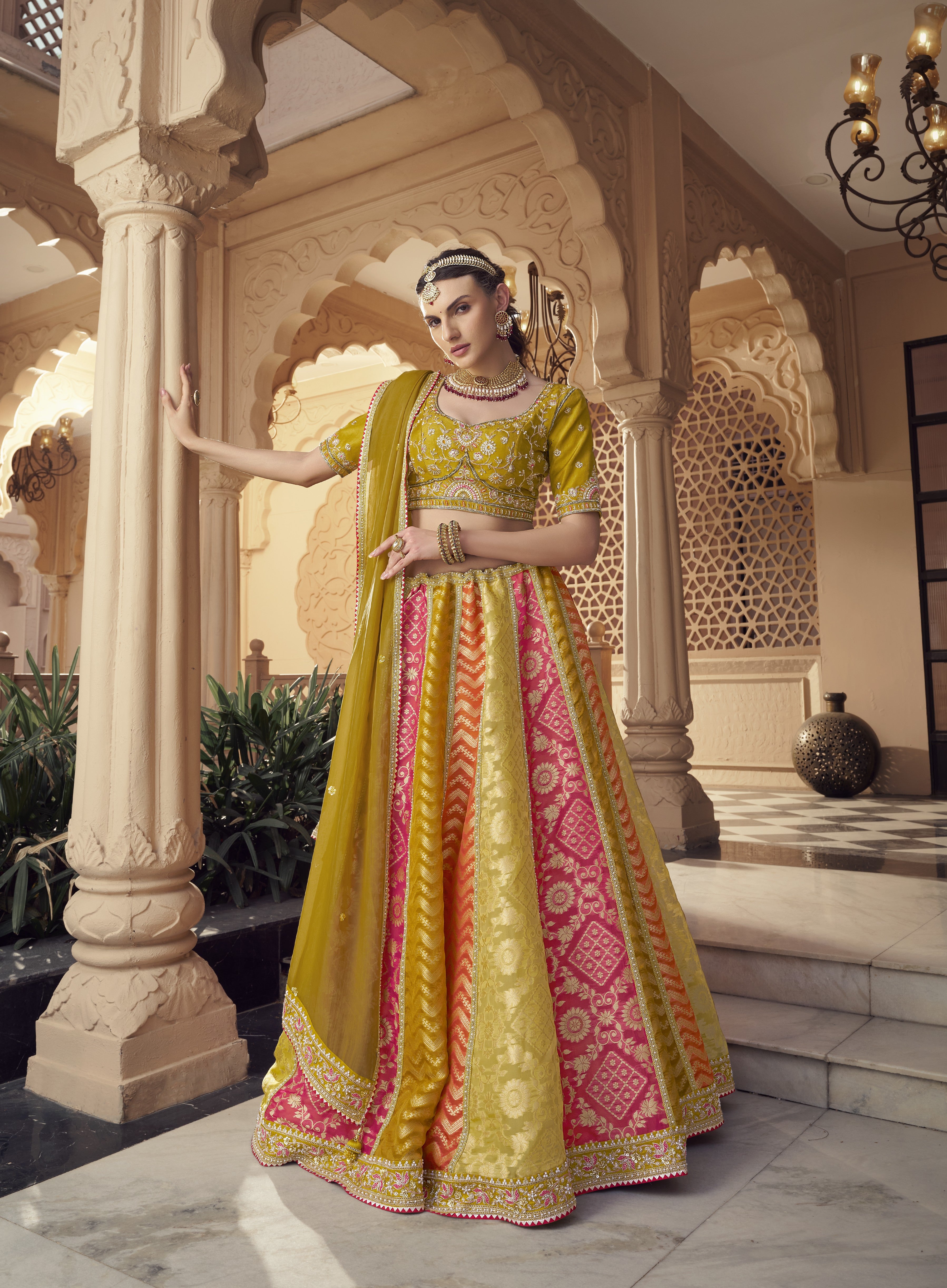 Woman in a colorful traditional Lehenga standing on a checkered floor.