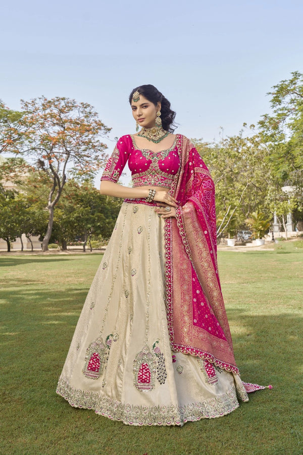 Woman in traditional Indian attire standing on grass with trees in the background